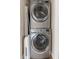 Stacked washer and dryer set, in a dedicated laundry area at 3668 Janus Way, Palm Harbor, FL 34685