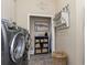 Well organized laundry room features a modern washer and dryer and ample storage solutions at 3668 Janus Way, Palm Harbor, FL 34685