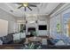 Inviting living room showcasing a fireplace, built-in cabinetry, and large windows for natural light at 3668 Janus Way, Palm Harbor, FL 34685