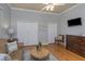 Comfortable living room with hardwood floors, ceiling fan, and decorative accent pieces at 3668 Janus Way, Palm Harbor, FL 34685