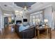 Bright living room with a fireplace, hardwood floors, large windows, and elegant decor at 3668 Janus Way, Palm Harbor, FL 34685