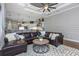 Spacious living room open to the kitchen featuring hardwood floors, stylish decor, and modern lighting at 3668 Janus Way, Palm Harbor, FL 34685