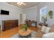 Comfortable living room with hardwood floors, a ceiling fan, and a writing desk at 3668 Janus Way, Palm Harbor, FL 34685