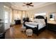 Luxurious main bedroom features tray ceilings, hardwood floors, and an abundance of natural light at 3668 Janus Way, Palm Harbor, FL 34685