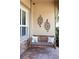 Cozy front porch featuring a wooden swing and decorative wall art at 3668 Janus Way, Palm Harbor, FL 34685