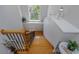 View of the staircase with natural light, oak handrail, and stylish metal spindles at 3668 Janus Way, Palm Harbor, FL 34685