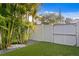Enclosed backyard with turf and tropical landscaping for privacy at 3815 W Obispo St, Tampa, FL 33629