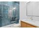 Modern bathroom featuring luxurious walk-in shower with elegant tile and a wood vanity at 3815 W Obispo St, Tampa, FL 33629