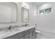 Upscale bathroom with double sinks, marble countertops, bathtub and modern fixtures at 3815 W Obispo St, Tampa, FL 33629