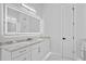 Modern bathroom with marble countertops, LED mirror, and white cabinets at 3815 W Obispo St, Tampa, FL 33629