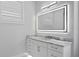 Bright bathroom featuring a vanity with marble countertop and backlit mirror at 3815 W Obispo St, Tampa, FL 33629