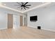 Spacious bedroom with wood floors, modern ceiling fan, and sliding doors to bathroom at 3815 W Obispo St, Tampa, FL 33629