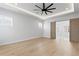 Bright bedroom featuring wood floors, recessed lighting, and sliding doors to ensuite bath at 3815 W Obispo St, Tampa, FL 33629