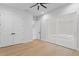 Spacious bedroom with wood floors, modern window shades and a ceiling fan for optimal comfort at 3815 W Obispo St, Tampa, FL 33629