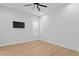 Bright empty bedroom with wood floor, a ceiling fan, and modern shutters for ample natural light at 3815 W Obispo St, Tampa, FL 33629