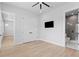 A bright bedroom showcases double closets, wood floors, and an ensuite bathroom for added privacy at 3815 W Obispo St, Tampa, FL 33629