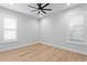 Sunlit bedroom with wood flooring, plantation shutters and a clean, minimalist design at 3815 W Obispo St, Tampa, FL 33629