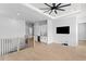 Bonus room featuring a wet bar, wood floors, and a modern ceiling fan at 3815 W Obispo St, Tampa, FL 33629