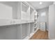 Custom walk-in closet with white shelving, drawers, and hanging rods for organized storage at 3815 W Obispo St, Tampa, FL 33629