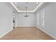 Elegant dining room featuring a modern chandelier, recessed lighting, and light wood floors at 3815 W Obispo St, Tampa, FL 33629