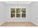 Bright dining area featuring a modern chandelier and large windows overlooking the pool at 3815 W Obispo St, Tampa, FL 33629