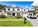 Beautiful two-story modern farmhouse with manicured lawn, black framed windows, and brick driveway at 3815 W Obispo St, Tampa, FL 33629