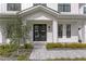 Elegant entryway with double doors, stone walkway, and manicured landscaping at 3815 W Obispo St, Tampa, FL 33629