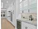 Well-lit kitchen featuring white cabinets, stainless steel appliances, and a beverage cooler at 3815 W Obispo St, Tampa, FL 33629