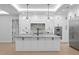 Stylish kitchen featuring stainless steel appliances, a large island, and modern pendant lighting at 3815 W Obispo St, Tampa, FL 33629