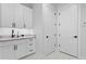 Laundry room features white cabinets, gray countertop, dark hardware and marble tile flooring at 3815 W Obispo St, Tampa, FL 33629