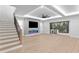 Bright living room featuring a fireplace, ceiling fan, wood floors, and sliding doors to the outside at 3815 W Obispo St, Tampa, FL 33629
