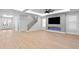 Bright living room featuring wood floors, a fireplace, staircase, and recessed lighting throughout at 3815 W Obispo St, Tampa, FL 33629