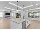 Open floorplan kitchen and living space showcasing island and entertainment center at 3815 W Obispo St, Tampa, FL 33629