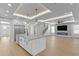 Open floorplan of kitchen and living room, with modern lighting and beautiful floors at 3815 W Obispo St, Tampa, FL 33629