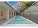Beautiful enclosed pool and jacuzzi on backyard patio at 3815 W Obispo St, Tampa, FL 33629