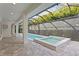 Enclosed pool and jacuzzi with patio, perfect for outdoor relaxation and entertainment at 3815 W Obispo St, Tampa, FL 33629