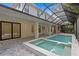 Enclosed outdoor pool with jacuzzi, accessible from the house at 3815 W Obispo St, Tampa, FL 33629
