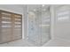 Modern bathroom featuring a glass-enclosed shower with marble tile and a built-in bench at 3815 W Obispo St, Tampa, FL 33629