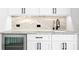 Modern wet bar featuring white cabinets, a gray countertop, and a stainless steel beverage cooler at 3815 W Obispo St, Tampa, FL 33629