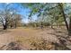 Picturesque backyard featuring mature trees, offering shade and privacy in a serene outdoor setting at 403 Indian Meadow Ct, Wimauma, FL 33598