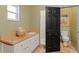 Bathroom area featuring a sink vanity, toilet, tile floors and walk-in shower at 403 Indian Meadow Ct, Wimauma, FL 33598