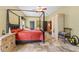 Spacious bedroom with a four-poster bed, elegant furnishings, and travertine floors at 403 Indian Meadow Ct, Wimauma, FL 33598
