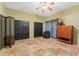 Spacious bedroom with tile floors, black interior doors and a ceiling fan at 403 Indian Meadow Ct, Wimauma, FL 33598