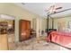 Bedroom with a four-poster bed and access to other rooms at 403 Indian Meadow Ct, Wimauma, FL 33598