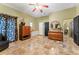 Bedroom featuring tile floors, black interior door and a decorative cabinet at 403 Indian Meadow Ct, Wimauma, FL 33598