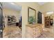 Walk-in closet with shelving, rods, and a dresser with an ornate mirror above at 403 Indian Meadow Ct, Wimauma, FL 33598