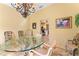 Elegant dining room with unique table, chandelier, and view to kitchen at 403 Indian Meadow Ct, Wimauma, FL 33598