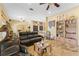 Open concept living room featuring travertine floors, comfortable seating, and stylish decor at 403 Indian Meadow Ct, Wimauma, FL 33598