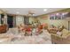 Inviting living room featuring stone floors, ceiling fan, and comfortable seating arrangement at 403 Indian Meadow Ct, Wimauma, FL 33598