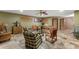 Open living room with tiled floor and comfortable seating around a central glass coffee table at 403 Indian Meadow Ct, Wimauma, FL 33598